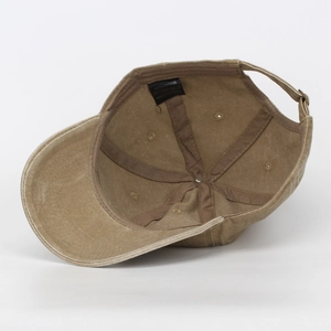 Macro detail view of the inner lining and care label on a washed cotton baseball cap.
