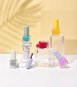 Artistic layout of multicolor water-based nail polish bottles with droplet texture