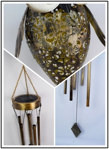 Detail of bronze metal solar wind chime with intricate hollow owl design and sun panel