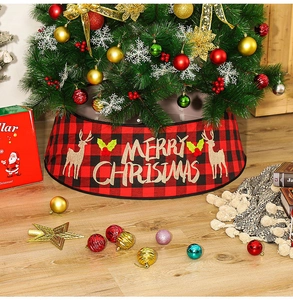 Close-up of red and black buffalo plaid Christmas tree skirt with reindeer print