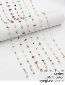Detailed macro view of colorful natural stone eyeglass chains with golden metal links