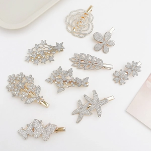 Detailed overhead shot of floral and star rhinestone hair clips on a white background