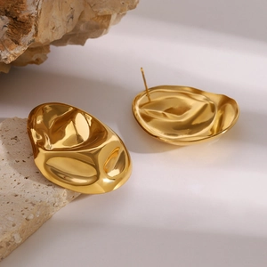 Hammered 18k gold plated stainless steel hoop earrings on natural rock display