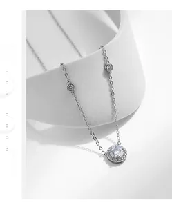 Macro shot of S925 silver necklace featuring a sparkling halo zircon pendant on a white base