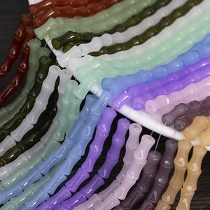 Detailed macro shot of 6x12mm bamboo-shaped glass beads in various vibrant colors for DIY