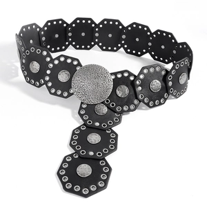 Detail of western vintage belt featuring black octagonal leather with hammered metal discs