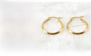 Detail view of 18K gold-plated stainless steel hoop earrings with 23.4mm diameter size