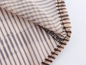 Gros plan du tissu en maille rayé beige et marron avec des détails de tricot précis