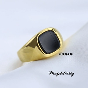 Macro shot of 12mm square black stone on a vintage gold stainless steel signet ring