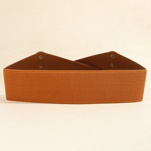 Detail of wide elastic waist belt with brown leather finish and metal snap fastener