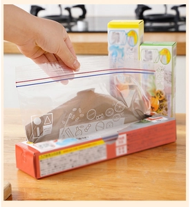 Close-up of a hand extracting a clear plastic food storage bag with double seal zipper