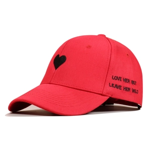 Detail of love quote embroidery on red cotton baseball cap with heart pattern