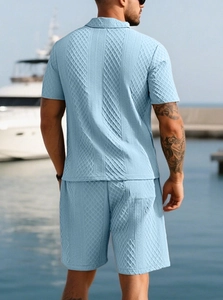Detail of light blue waffle knit texture on men's summer polo shirt and shorts set