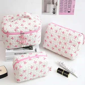 Three-piece quilted cream makeup bag set with pink bow prints and pearl charms