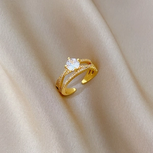 Adjustable gold plated open ring featuring a double layered crisscross design with zircons