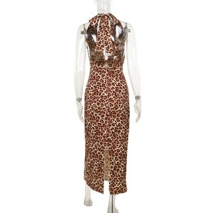 Detail view of the back slit and leopard print on a backless bodycon maxi dress