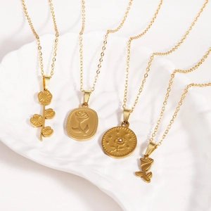 Romantic gold rose pendant necklaces in stainless steel for women displayed on tray