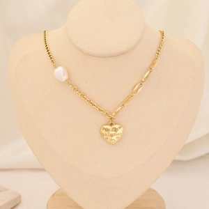 Detail of gold heart pendant engraved with Be My Valentine and asymmetric pearl chain