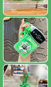 Detailed view of a green translucent panda shaker keychain with liquid glitter sand