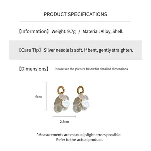 Detail view of round shell tassel earrings showing 6cm height and 2.5cm width dimensions