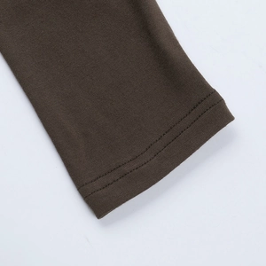 Detail shot of brown knit dress showing high-quality double-needle stitching and fabric