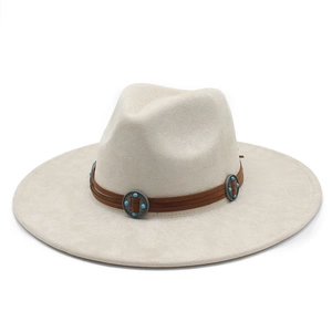 Detail of suede cowboy hat with brown leather band and turquoise metal studs
