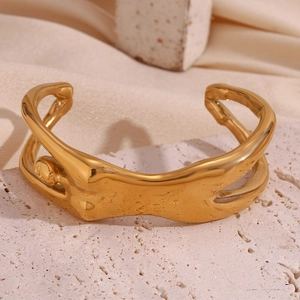Close-up of 18K gold plated stainless steel cuff bracelet with liquid metal design on stone