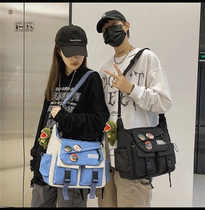 Detail of crossbody messenger bags with dinosaur plush pendants and decorative badges