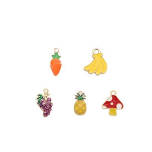 Detailed view of colorful enamel fruit and vegetable charms with gold borders for DIY jewelry