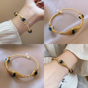 Gold-plated wire-wrapped bracelet with dark gemstone and freshwater pearls for women