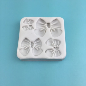 White silicone mold with four bow shapes for chocolate, fondant and DIY crafts