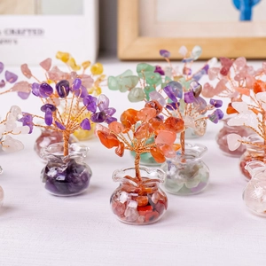 Miniature natural crystal money trees with wire branches and stones in glass jars