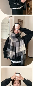 Detail of classic plaid scarf featuring soft fringe and thick woven check pattern