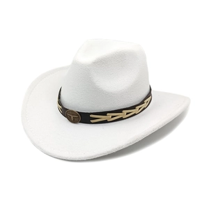 Detail of white felt cowboy hat featuring brown leather band with vintage metal bull emblem