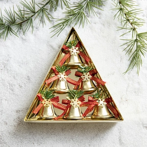 Set of 6 gold Christmas bells with red bows in a triangle gift box on snow