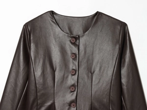 Close-up of a dark brown faux leather jacket featuring a button-down collar and texture