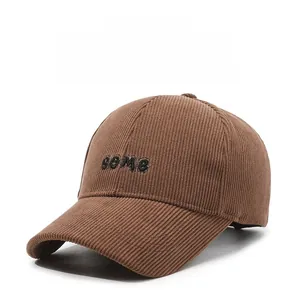 Close-up of brown corduroy baseball cap with black some letter embroidery details