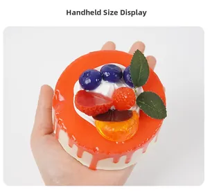 Handheld size display showing high-rebound PU foam round mousse cake with red glaze