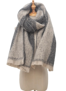 Detail of beige and gray plaid boucle yarn scarf with soft fringe edges and thick texture