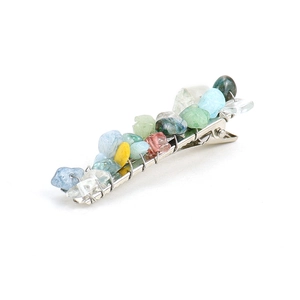 Detail of handmade hair clip with natural colorful crystal stones and wire-wrapped finish