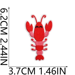 Detail view of red lobster embroidered patch with precise measurement markings