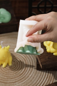 Detail showing the easy demolding process of a cartoon dragon silicone candle mold