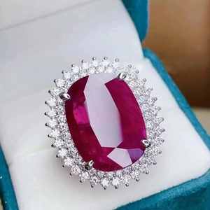 Oval cut ruby red stone ring with diamond halo in a turquoise velvet gift box
