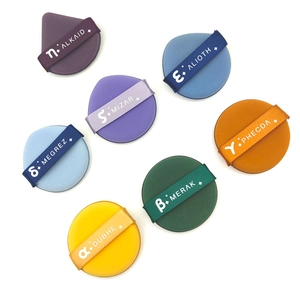 Flat lay of colorful soft makeup puffs in purple, blue, orange, green, and yellow hues