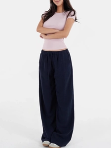 Detail view of navy blue wide leg trousers with elastic drawstring waist and linen texture