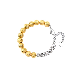 Detailed view of lava rock beads joined with a thick stainless steel chain bracelet
