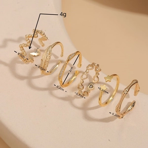 6-piece set of gold rings featuring heart, star, and feather designs in boho style