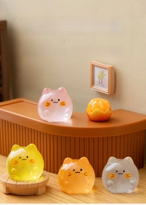 Macro detail of miniature luminous cat resin figurines in soft indoor scenery decoration