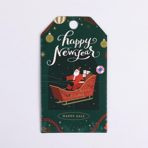 Detail of green Christmas gift tags featuring Santa on a sled with holiday greetings