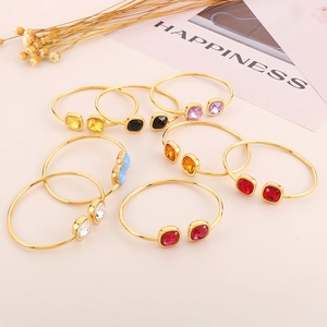 Chic gold-plated open hollow cuff bracelet with vibrant square gemstones and modern design